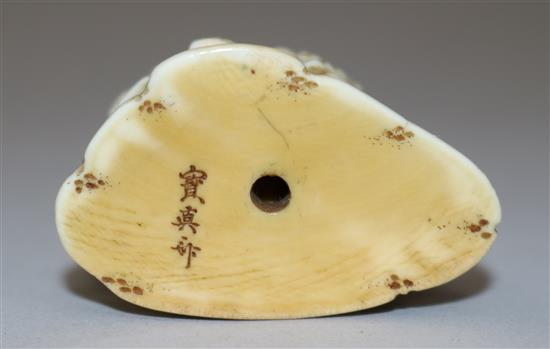 A Japanese ivory netsuke of a figure playing the flute standing by an ox, 19th century, 4.4cm